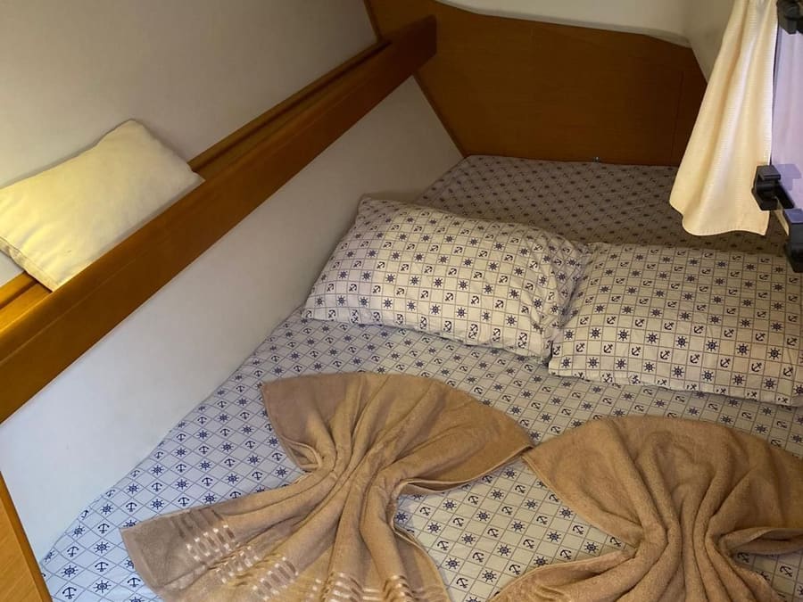 A cabin on the Jeanneau Sun Odyssey 36i with a made-up double bed